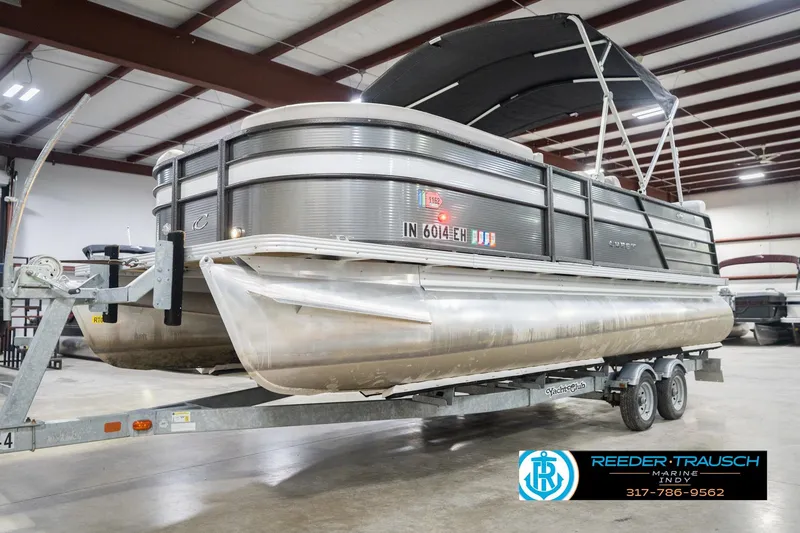 Slide: The Image of 2021 Crest SLRC 220 pontoon boat on trailer in indoor showroom. - 3