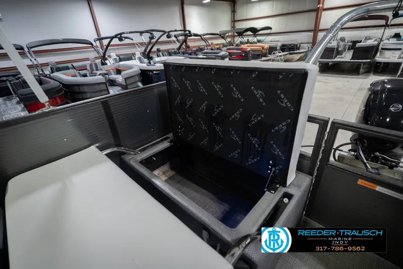 Slide: The Image of 2021 Crest SLRC 220 boat interior with open storage compartment in showroom. - 34