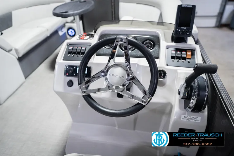 Slide: The Image of Steering console of 2021 Crest SLRC 220 boat with modern controls and navigation system. - 35