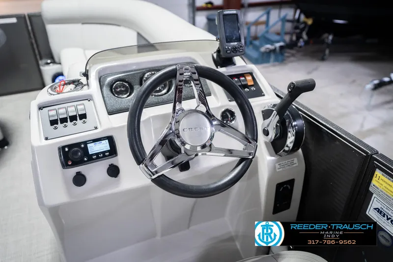 Slide: The Image of Steering console of 2021 Crest SLRC 220 boat with modern controls and navigation equipment. - 36