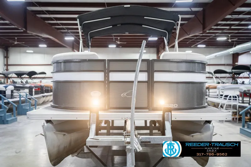 Slide: The Image of 2021 Crest SLRC 220 pontoon boat in indoor showroom with lights on. - 4