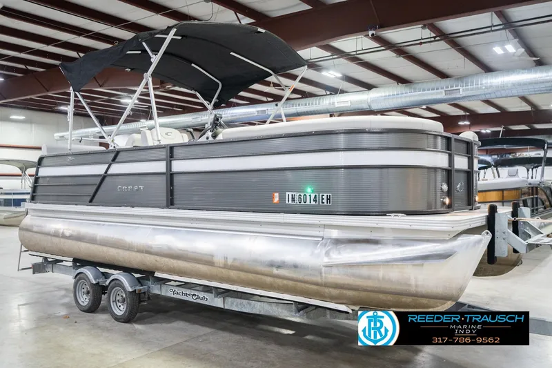 Slide: The Image of 2021 Crest SLRC 220 pontoon boat on trailer in indoor showroom. - 5