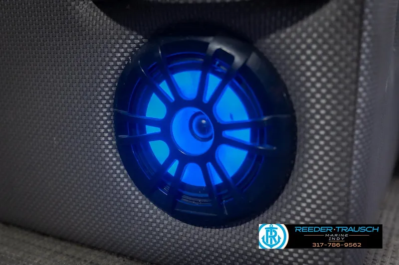 Slide: The Image of ```markdown Blue LED speaker on 2021 Crest SLRC 220 boat, textured surface, Reeder-Trausch Marine logo. ``` - 50