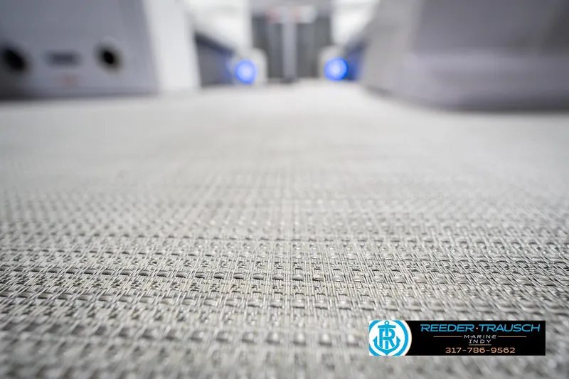 Slide: The Image of Close-up of textured flooring on a 2021 Crest SLRC 220 boat interior. - 52