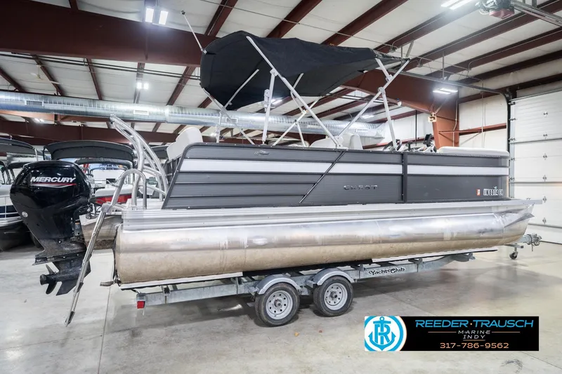 Slide: The Image of 2021 Crest SLRC 220 pontoon boat with Mercury engine in indoor storage. - 7