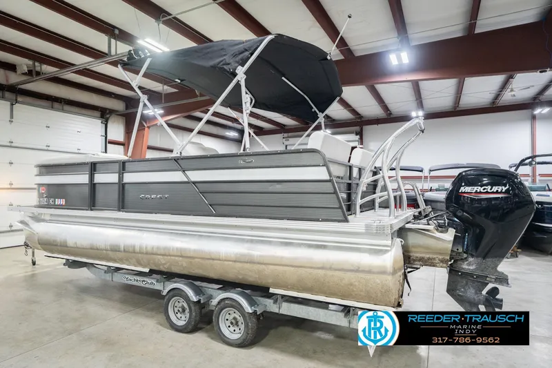 Slide: The Image of 2021 Crest SLRC 220 pontoon boat with Mercury engine in indoor showroom. - 9