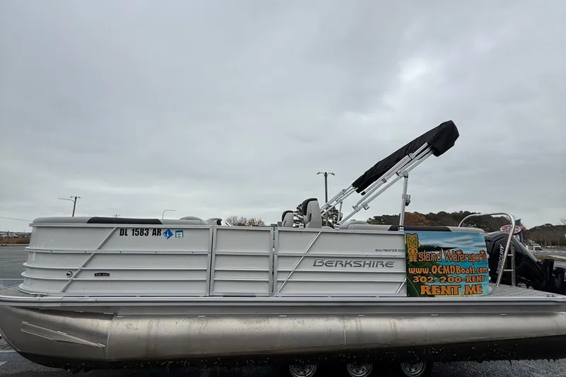 Slide: The Image of 2025 Berkshire 22RFX LE 2.75 pontoon boat with rental advertisement, parked outdoors. - 5