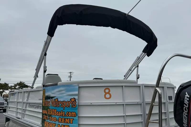 Slide: The Image of 2025 Berkshire 22RFX LE 2.75 pontoon boat with canopy and rental advertisement. - 6