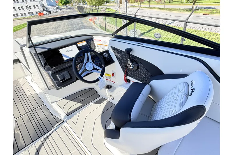 Slide: The Image of 2026 Sea Ray SPX 210 boat interior with steering wheel and captain's seat. - 12