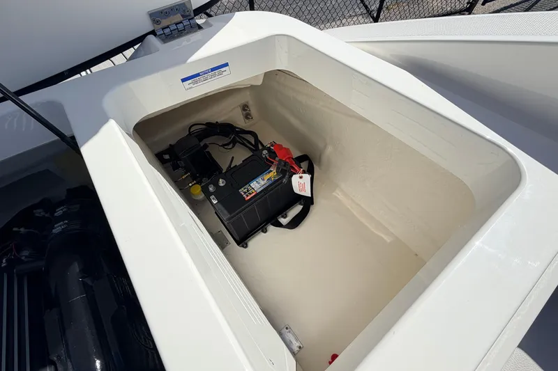 Slide: The Image of Battery compartment of 2026 Sea Ray SPX 210 boat, showcasing internal storage and wiring. - 16