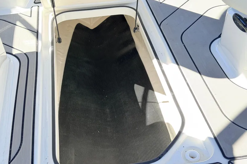Slide: The Image of Storage compartment on 2026 Sea Ray SPX 210 boat deck, open and empty. - 20