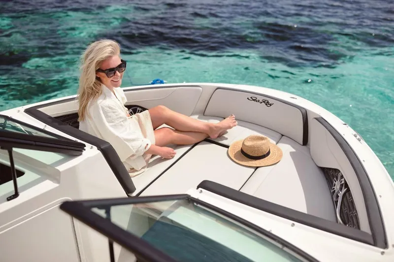 Slide: The Image of Woman relaxing on a 2026 Sea Ray SPX 210 boat in clear blue waters. - 30