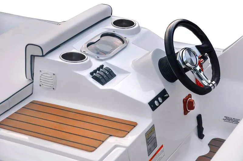 Slide: The Image of 2026 AB Inflatables ABJET 330 boat interior with steering wheel and seating, displayed at Tender Care Boats. - 2