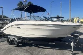 The Image of 2024 Sea Ray SPX 210 Outboard boat on trailer, parked outdoors. - 0