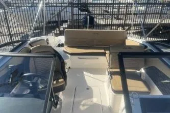 Slide: The Image of 2024 Sea Ray SPX 210 Outboard boat interior with seating and steering wheel. - 10