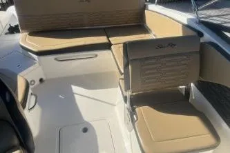 Slide: The Image of 2024 Sea Ray SPX 210 Outboard boat interior with tan seating and modern design. - 11