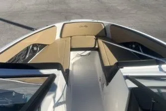 Slide: The Image of 2024 Sea Ray SPX 210 Outboard boat interior with tan seating and sleek design. - 9