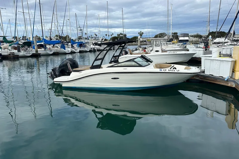 The Image of 2022 Sea Ray SPX 190 Outboard boat docked in a marina under clear blue skies. - 0