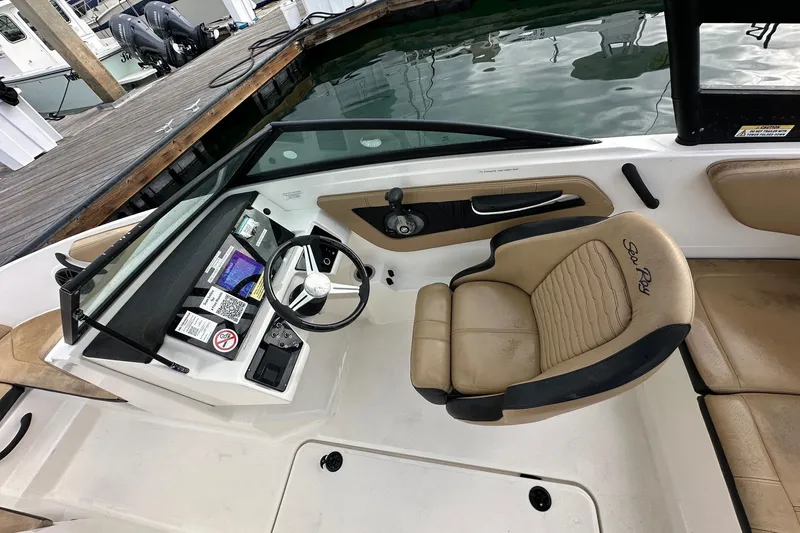 Slide: The Image of 2022 Sea Ray SPX 190 Outboard boat docked in a marina, surrounded by other vessels. - 10