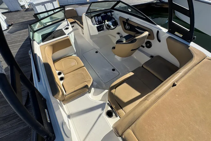 Slide: The Image of 2022 Sea Ray SPX 190 Outboard interior with tan seating and modern dashboard. - 18