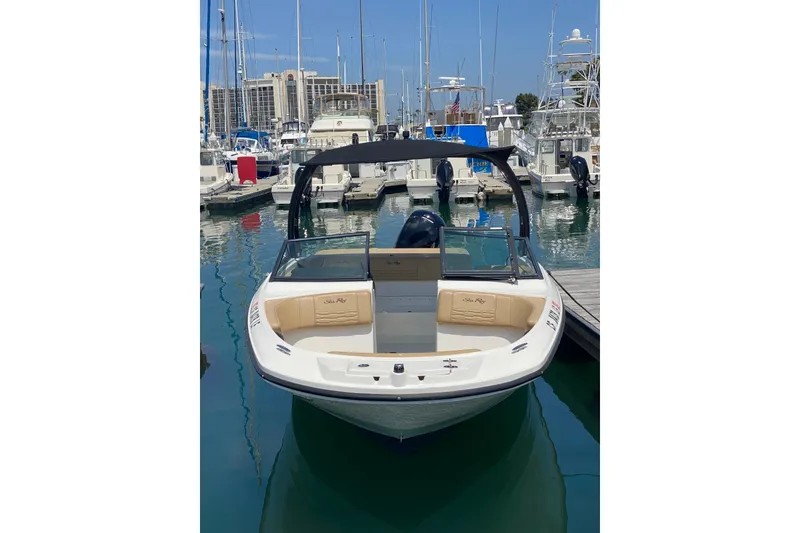 Slide: The Image of 2022 Sea Ray SPX 190 Outboard boat docked in a marina under clear blue skies. - 4