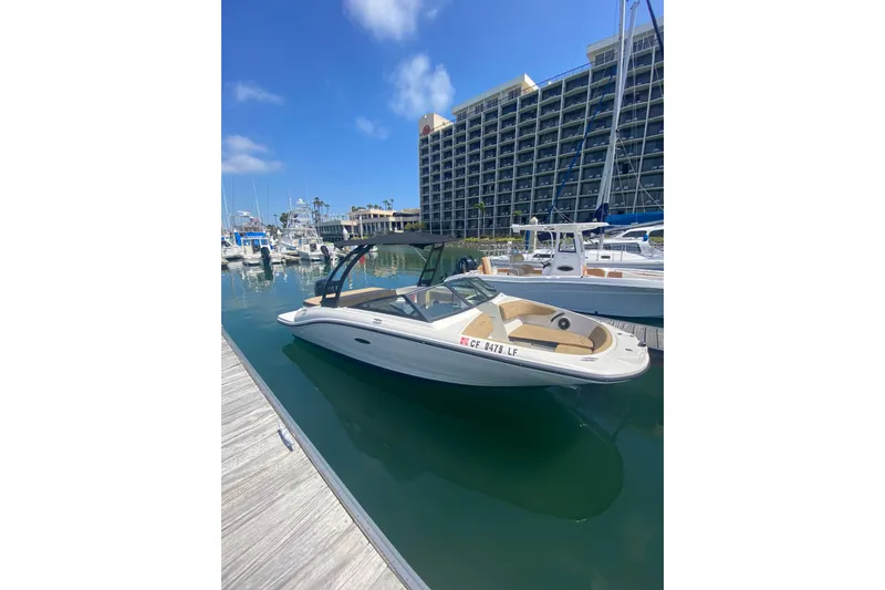Slide: The Image of 2022 Sea Ray SPX 190 Outboard boat docked in a marina with clear blue skies. - 5