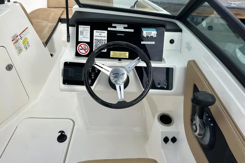 Slide: The Image of 2022 Sea Ray SPX 190 Outboard boat docked in a marina with sailboats. - 9