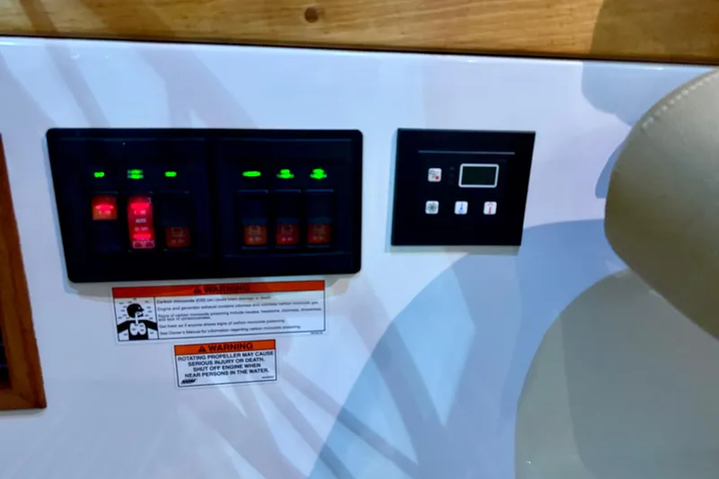 Slide: The Image of Control panel of a 2011 Back Cove 37 boat with warning labels. - 10