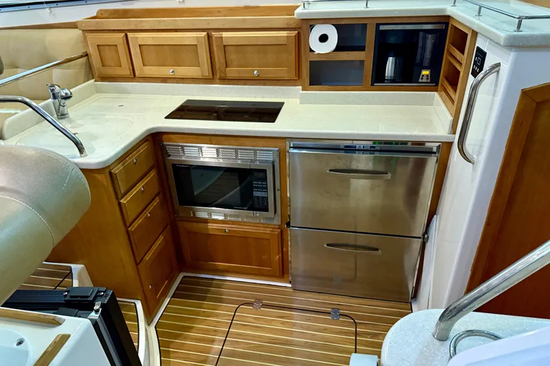 Slide: The Image of Luxurious 2011 Back Cove 37 yacht kitchen with modern appliances and wooden cabinetry. - 13