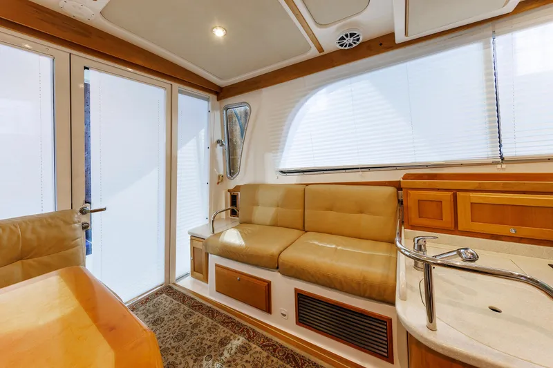 Slide: The Image of Interior of 2011 Back Cove 37 yacht with beige seating and wooden cabinetry. - 40