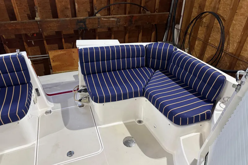 Slide: The Image of 2011 Back Cove 37 boat with blue striped seating in a wooden interior setting. - 5