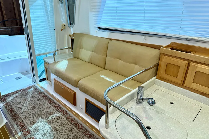 Slide: The Image of Interior of 2011 Back Cove 37 yacht with beige seating and kitchenette. - 7
