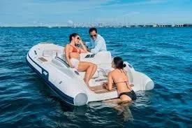 Slide: The Image of 2026 AB Inflatables ABJET 430XP on water with three people enjoying a sunny day. - 8