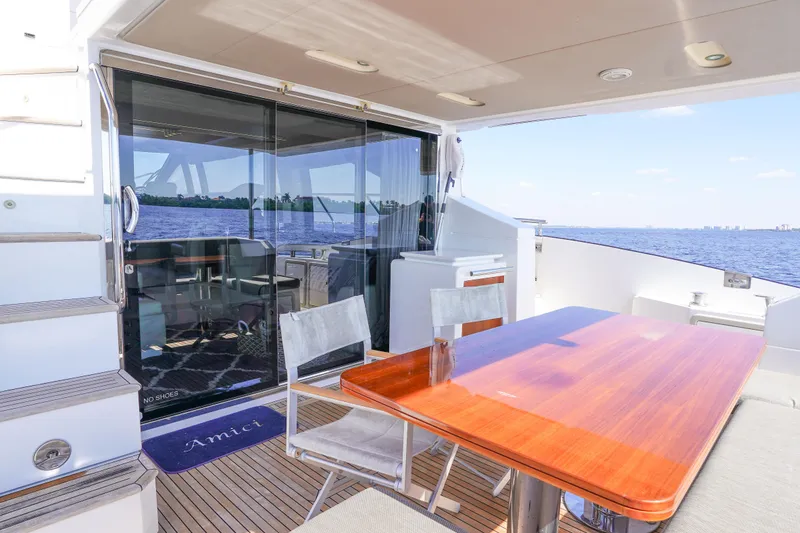 Slide: The Image of 2017 Azimut 66 Flybridge yacht deck with dining area and ocean view. - 10