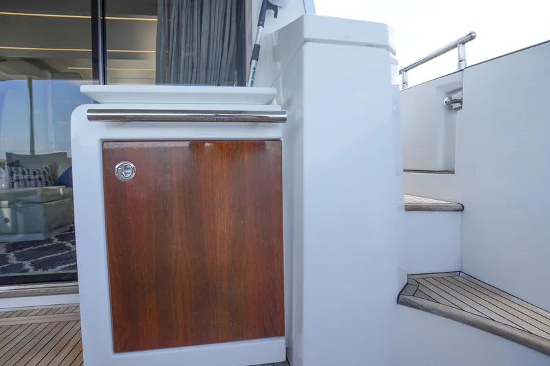 Slide: The Image of 2017 Azimut 66 Flybridge yacht interior with wooden cabinet and staircase detail. - 13