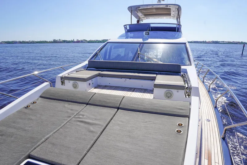 Slide: The Image of 2017 Azimut 66 Flybridge yacht with spacious deck and luxurious seating on open water. - 17