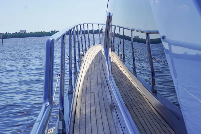 Slide: The Image of Side deck view of 2017 Azimut 66 Flybridge yacht with sleek railing and water reflection. - 20
