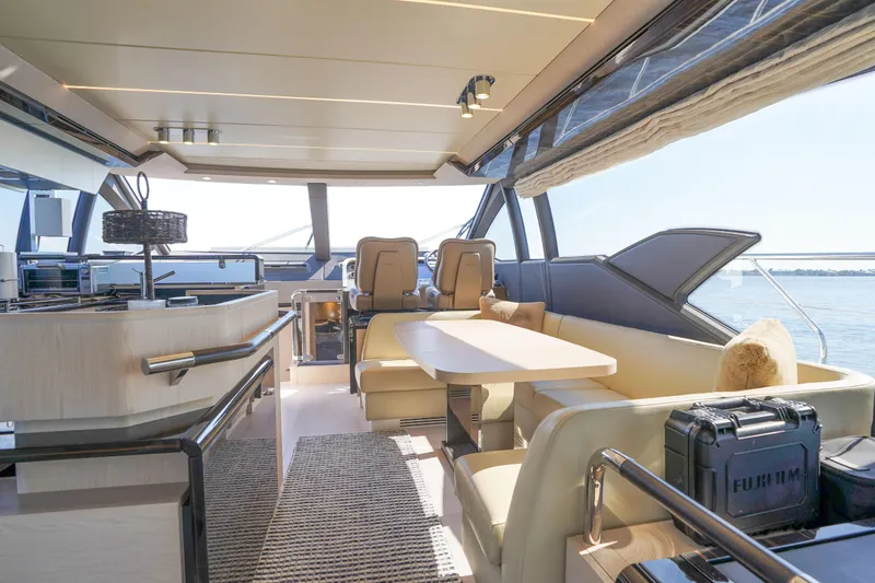 Slide: The Image of Luxurious interior of 2017 Azimut 66 Flybridge yacht with elegant seating and panoramic windows. - 27