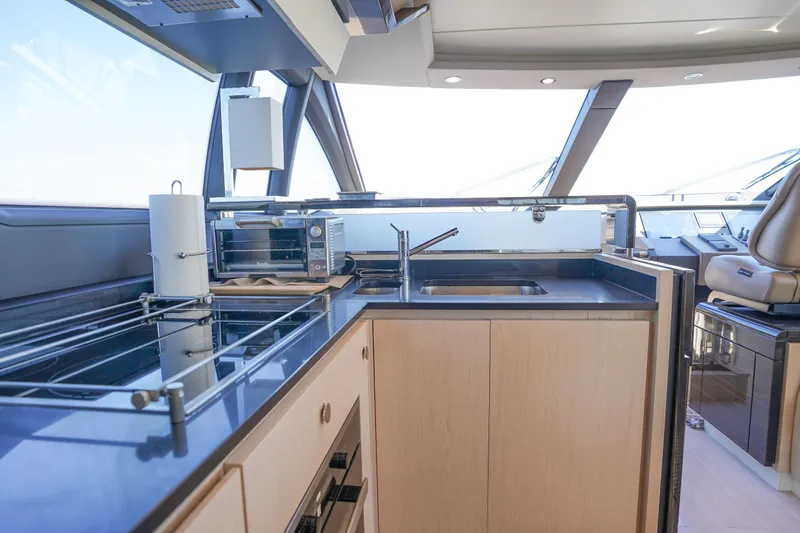 Slide: The Image of Modern kitchen area on 2017 Azimut 66 Flybridge yacht with sleek countertops and appliances. - 30
