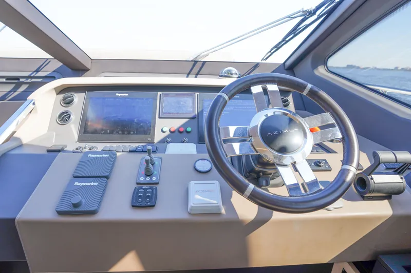 Slide: The Image of Helm of 2017 Azimut 66 Flybridge yacht with advanced navigation controls and steering wheel. - 34
