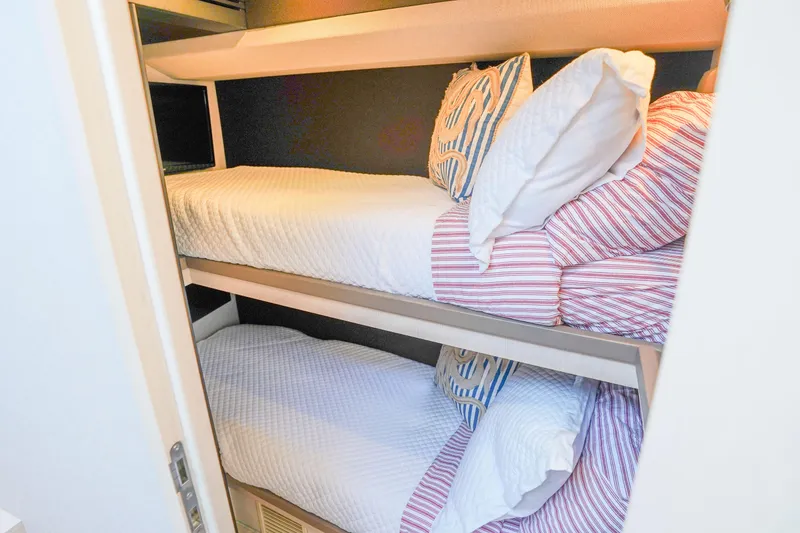 Slide: The Image of Bunk beds in 2017 Azimut 66 Flybridge yacht cabin with striped bedding. - 38