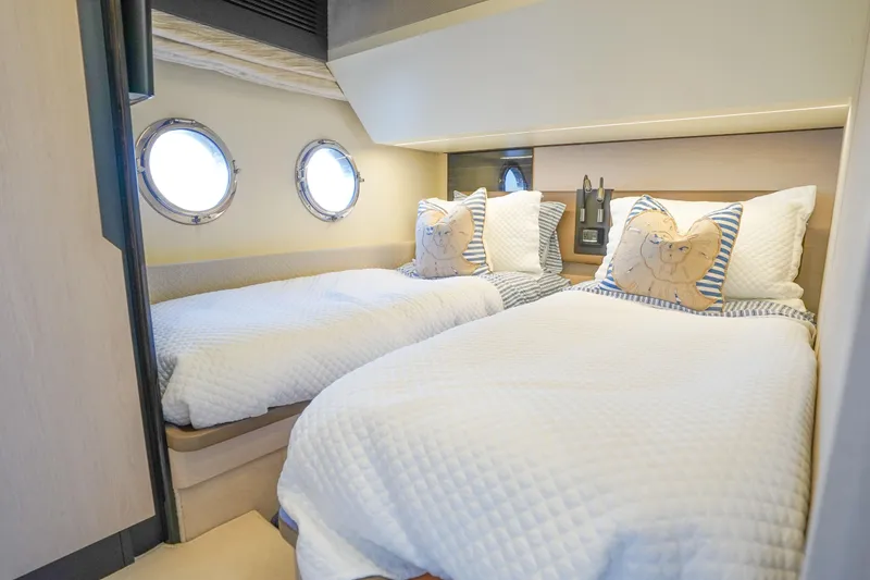 Slide: The Image of Cozy twin bedroom in 2017 Azimut 66 Flybridge yacht with porthole windows. - 39