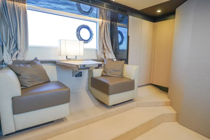 Slide: The Image of Luxurious interior of 2017 Azimut 66 Flybridge yacht with elegant seating and window view. - 46