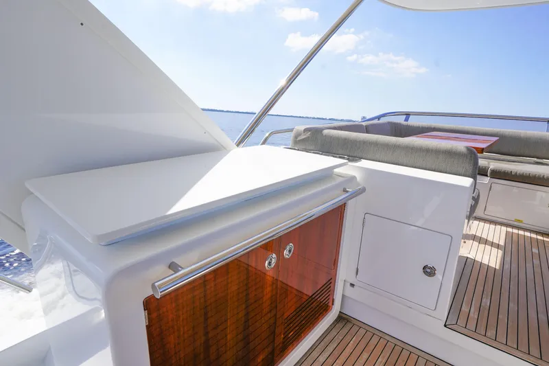 Slide: The Image of 2017 Azimut 66 Flybridge yacht deck with seating and storage, overlooking the ocean. - 54