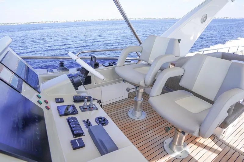 Slide: The Image of Flybridge helm of 2017 Azimut 66 yacht with dual seats and control panel. - 57