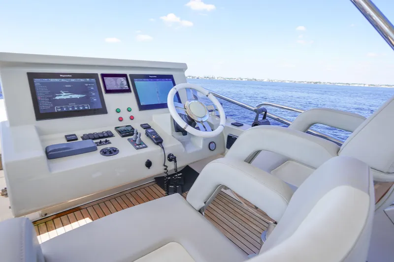 Slide: The Image of Flybridge helm of 2017 Azimut 66 yacht with modern navigation controls and ocean view. - 58