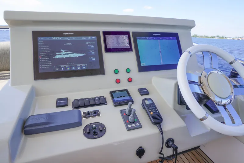 Slide: The Image of Cockpit of 2017 Azimut 66 Flybridge yacht with navigation screens and controls. - 59