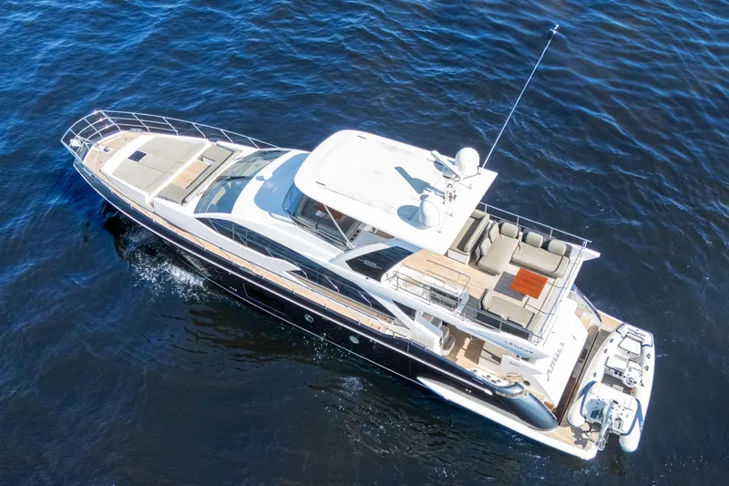 Slide: The Image of 2017 Azimut 66 Flybridge yacht cruising on open water, aerial view. - 6
