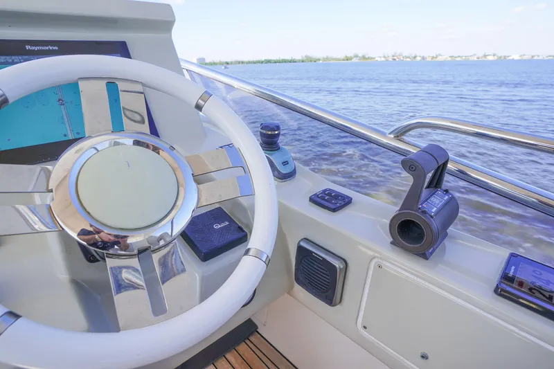 Slide: The Image of Steering wheel and controls of 2017 Azimut 66 Flybridge yacht with water view. - 60