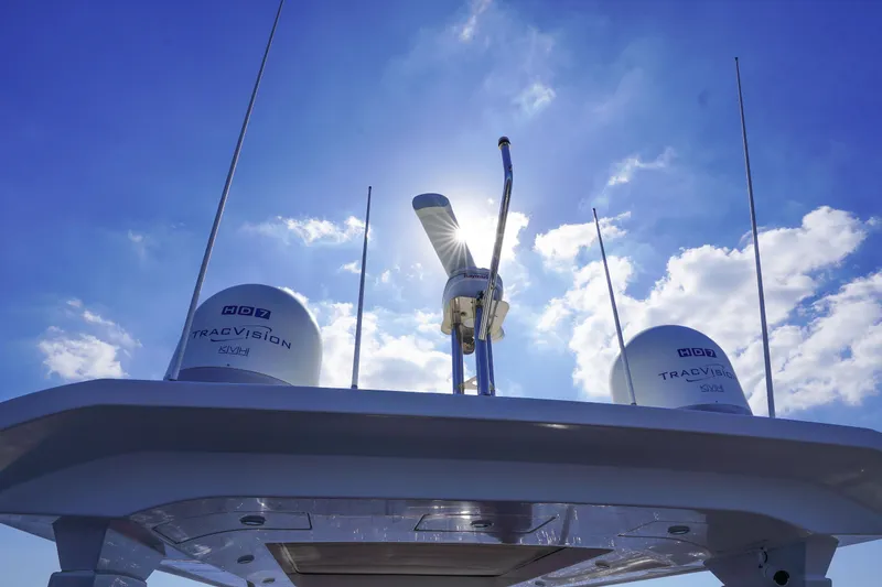 Slide: The Image of 2017 Azimut 66 Flybridge yacht with TracVision antennas under a bright blue sky. - 61